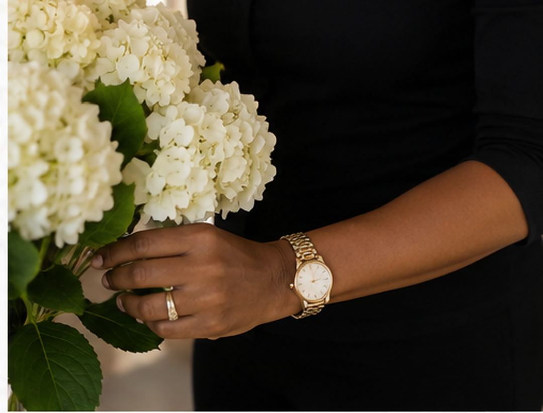 A woman arranging white hydrangeas in a vase